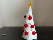 White Christmas tree with red small felt balls and has yellow color star on top.