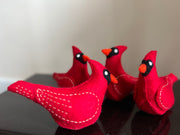 Group of Cardinal bird toy in red with orange color nose and white lining of thread 