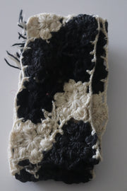 Hand knitted scarf in black and white color.